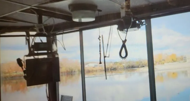 Slide: The Image of Interior view of a 1985 custom passenger boat with river scenery. - 7