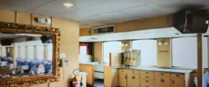 Slide: The Image of Interior of a 1985 custom dinner excursion passenger vessel with ornate mirror and kitchen area. - 8