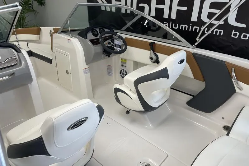 Slide: The Image of 2024 Chaparral 19 SSi OB boat interior with modern seating and steering console. - 4