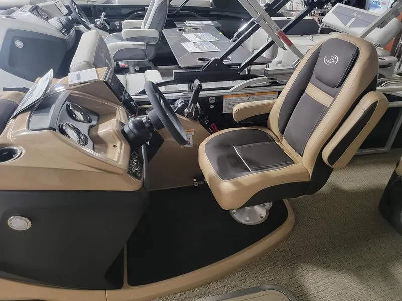 Slide: The Image of 2025 Barletta C24U boat interior with tan and black captain's chair and dashboard. - 13
