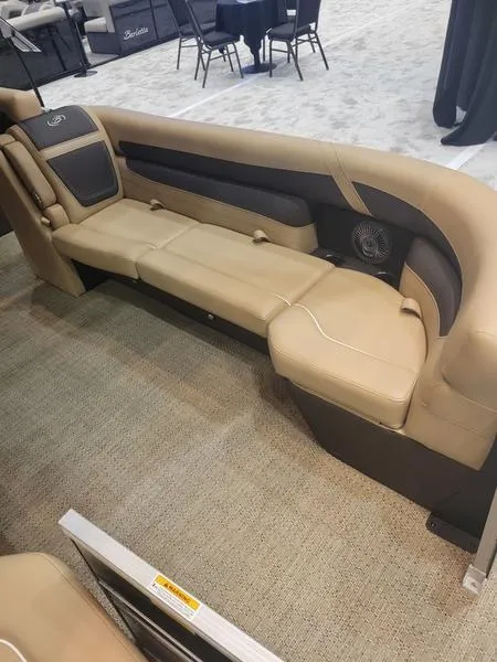 Slide: The Image of 2025 Barletta C24U boat interior with beige seating and carpeted flooring. - 20