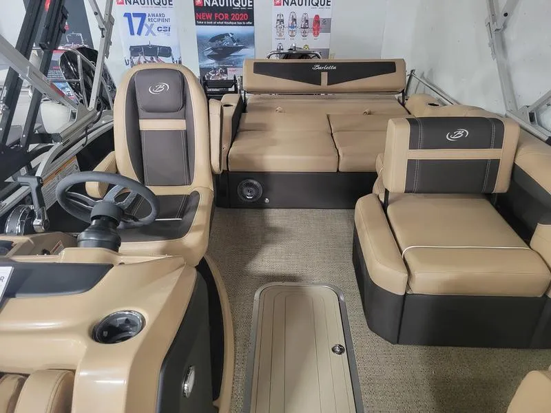 Slide: The Image of 2025 Barletta C24U boat interior with tan and black seating. - 21