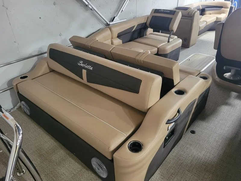 Slide: The Image of 2025 Barletta C24U pontoon boat interior with tan and black seating. - 22