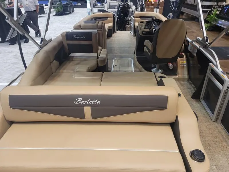 Slide: The Image of 2025 Barletta C24U pontoon boat interior with tan seating and modern design. - 24
