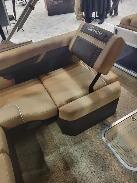 Slide: The Image of 2025 Barletta C24U pontoon boat seating with beige upholstery and branded headrest. - 28