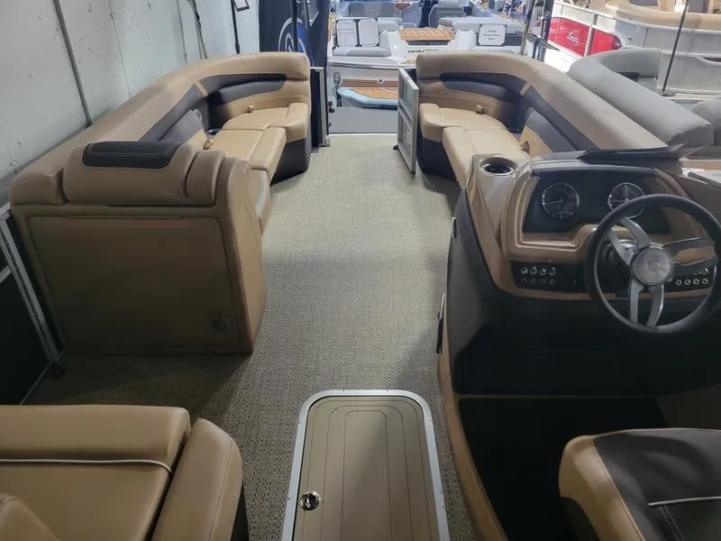 Slide: The Image of Interior of 2025 Barletta C24U pontoon boat with luxurious seating and modern dashboard. - 9