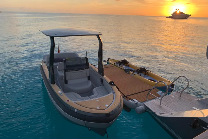 Slide: The Image of Carbon Craft CC 160 boat docked at sunset, 2016 model, with serene ocean backdrop. - 11