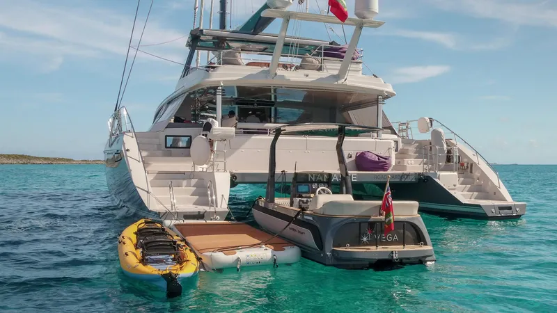 Slide: The Image of Luxury yacht with paddleboards and tender, Carbon Craft CC 160, 2016 model, anchored in clear waters. - 3