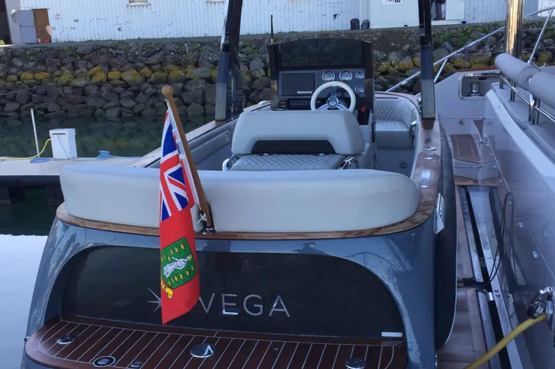 Slide: The Image of Carbon Craft CC 160 boat, 2016 model, docked with a flag at the stern. - 5