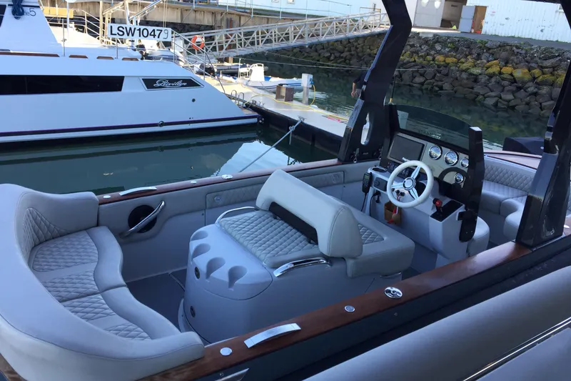 Slide: The Image of Luxurious 2016 Carbon Craft CC 160 boat interior with plush seating and modern dashboard. - 6