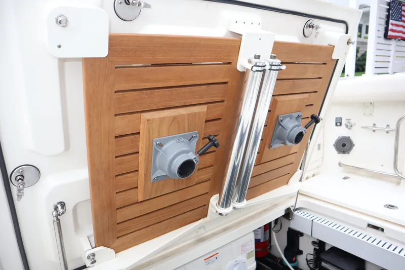 Slide: The Image of 2022 Boston Whaler 380 Outrage boat interior with wooden paneling and metal fixtures. - 16