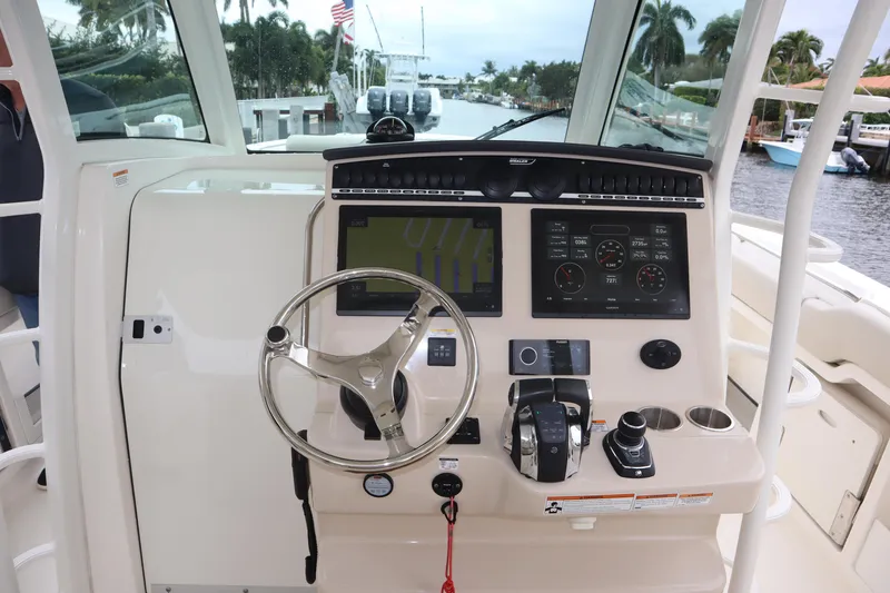 Slide: The Image of 2022 Boston Whaler 380 Outrage helm with modern controls and navigation displays. - 19