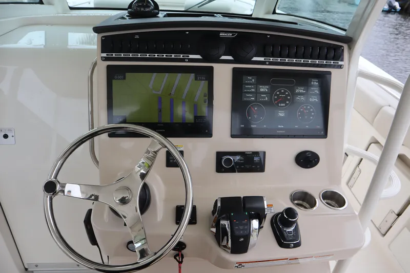 Slide: The Image of Boston Whaler 380 Outrage 2022 helm with advanced navigation and control systems. - 20