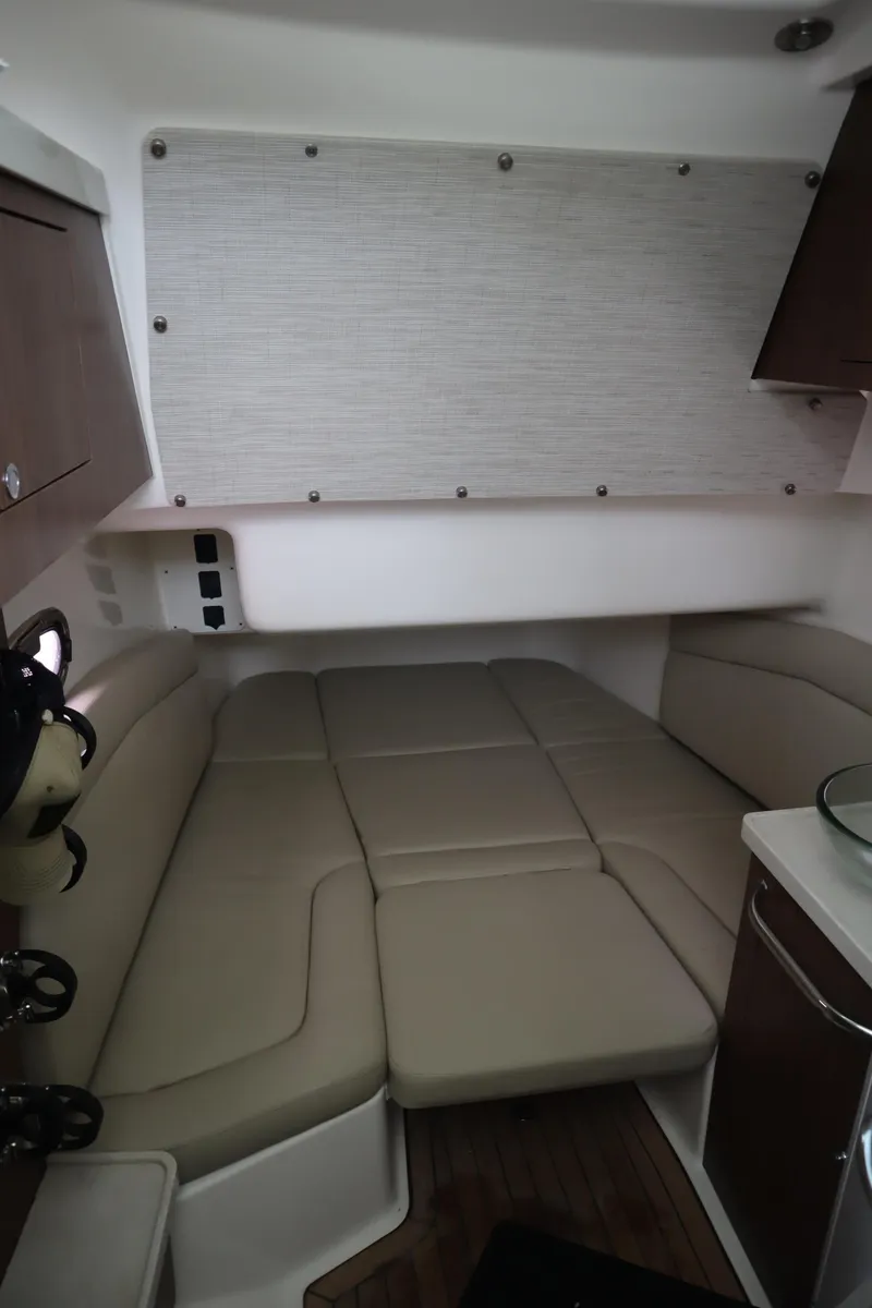 Slide: The Image of 2022 Boston Whaler 380 Outrage cabin interior with beige seating and modern design. - 26
