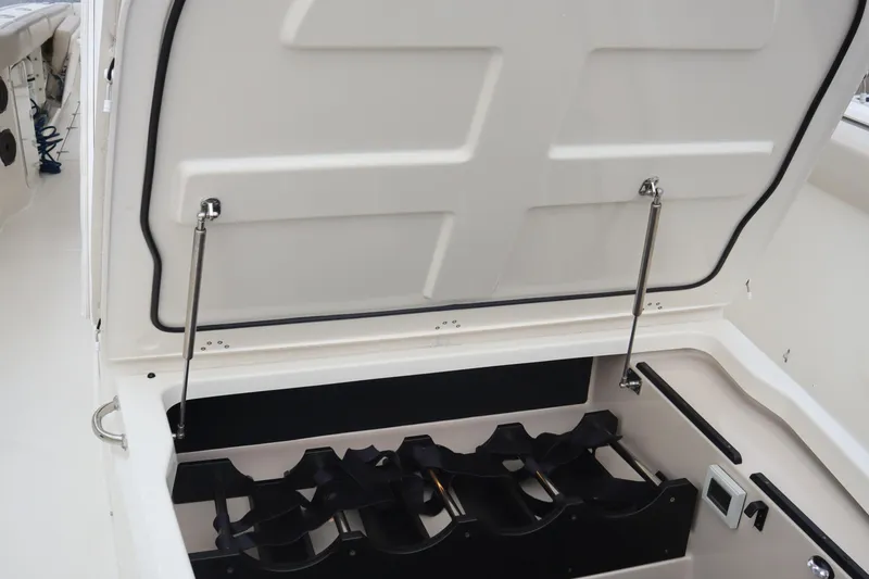 Slide: The Image of Storage compartment on a 2022 Boston Whaler 380 Outrage boat, featuring organized interior space. - 29
