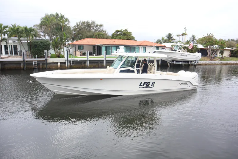 Slide: The Image of 2022 Boston Whaler 380 Outrage boat on a calm waterway. - 31