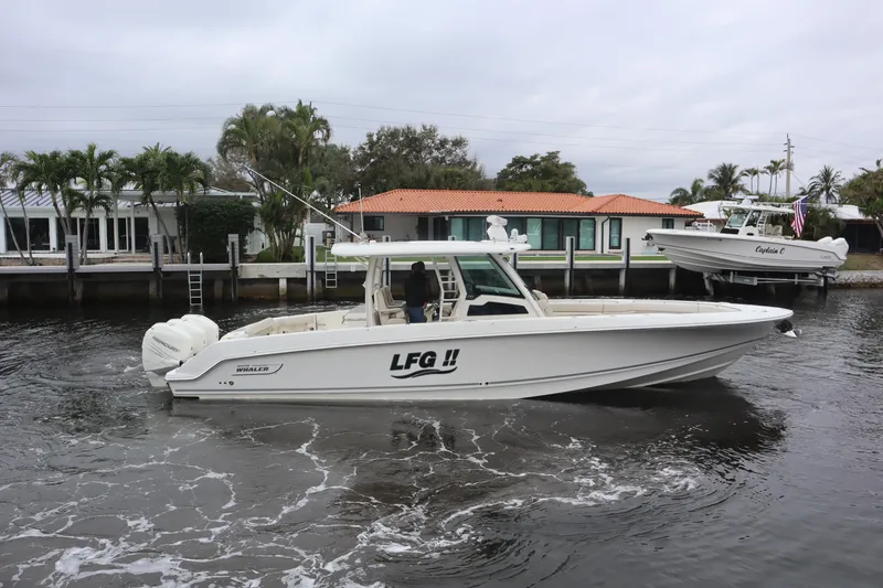 Slide: The Image of 2022 Boston Whaler 380 Outrage boat cruising on a calm waterway. - 6