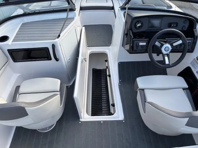 Slide: The Image of 2020 Yamaha Boats SX190 interior with seating, steering wheel, and storage compartment. - 10