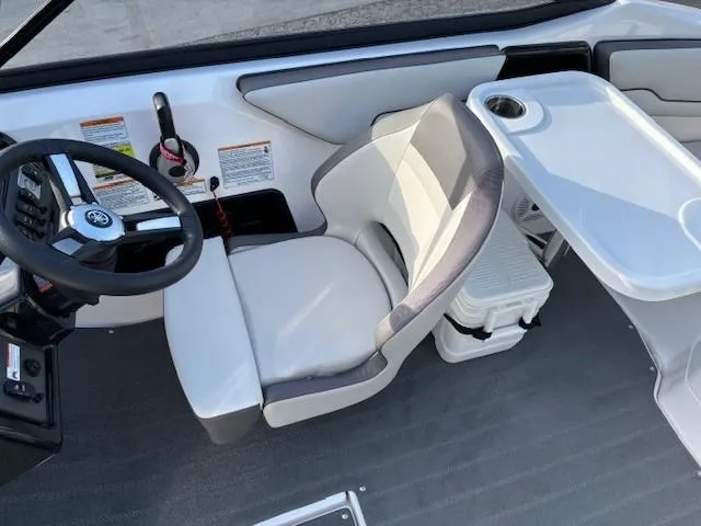 Slide: The Image of 2020 Yamaha Boats SX190 interior with steering wheel, seat, and console. - 13