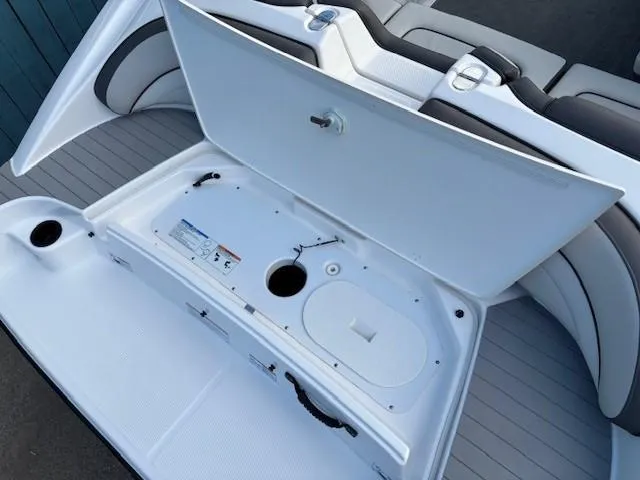 Slide: The Image of 2020 Yamaha Boats SX190 storage compartment open, showcasing interior design and seating. - 29
