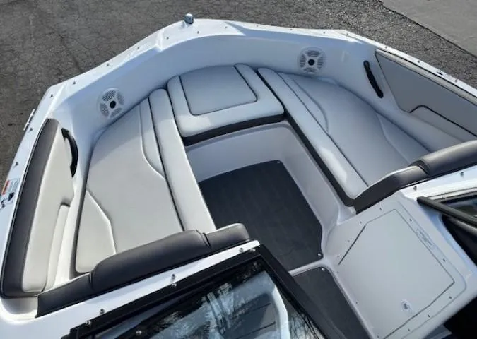 Slide: The Image of 2020 Yamaha Boats SX190 interior with white cushioned seating and speakers. - 7