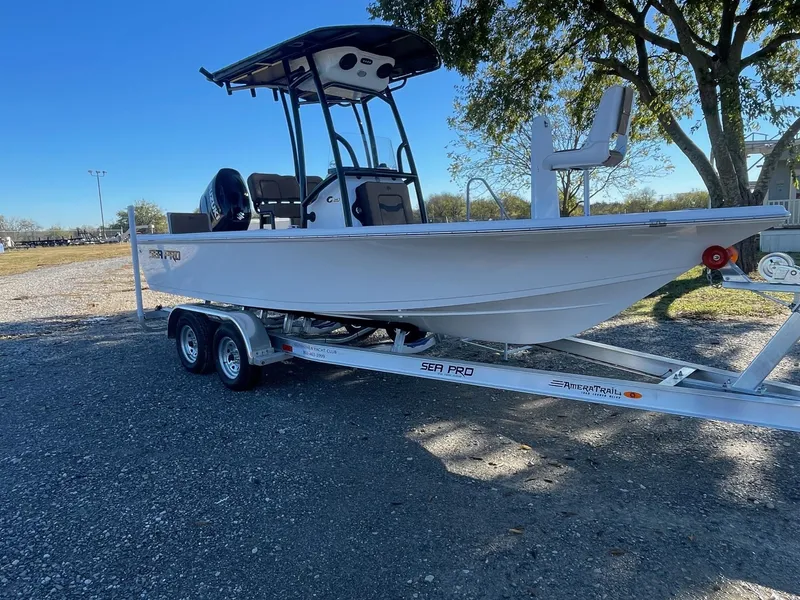 The Image of 2025 Sea Pro 210 DLX boat on trailer, parked outdoors. - 1