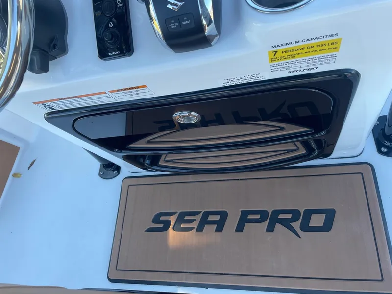 Slide: The Image of Sea Pro 210 DLX 2025 boat dashboard with controls and logo mat. - 13