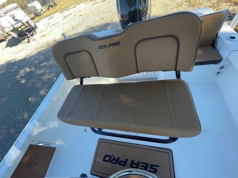 Slide: The Image of 2025 Sea Pro 210 DLX boat with tan seating and logo. - 14