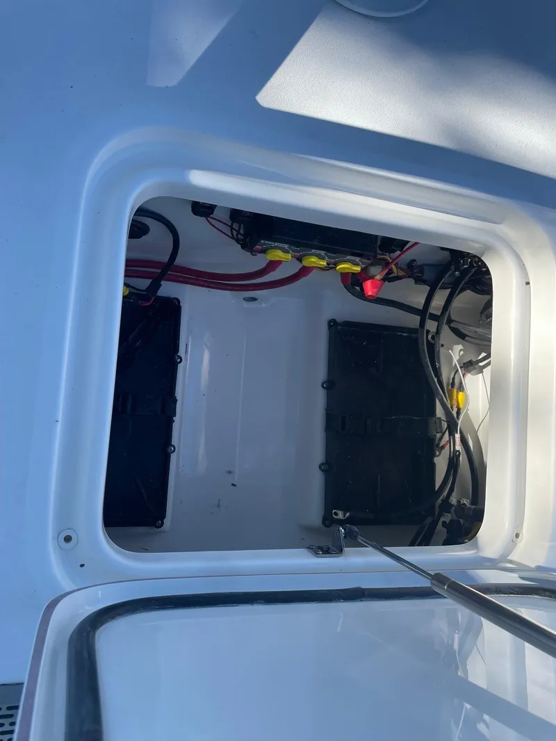 Slide: The Image of 2025 Sea Pro 210 DLX boat battery compartment with wiring and connections. - 18
