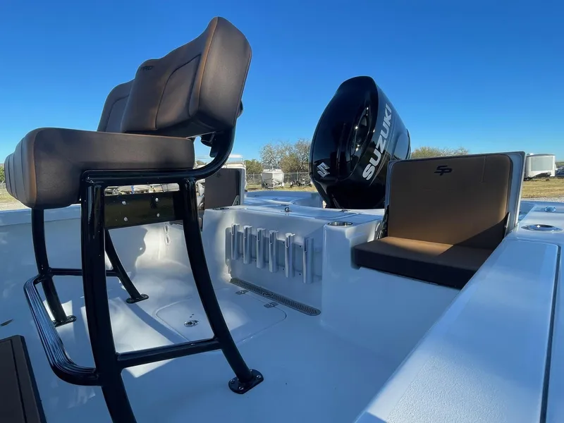 Slide: The Image of 2025 Sea Pro 210 DLX boat interior with seating and Suzuki outboard motor. - 4