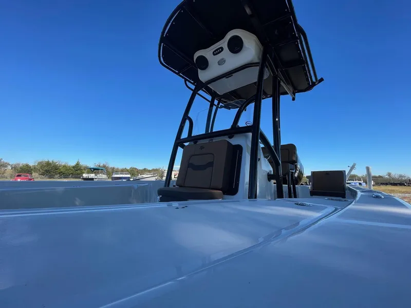 Slide: The Image of 2025 Sea Pro 210 DLX boat with T-top against clear blue sky. - 8