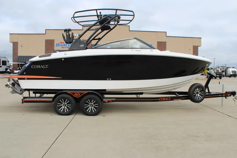 Slide: The Image of 2024 Cobalt R6 boat on trailer, black and white design, parked outdoors. - 1