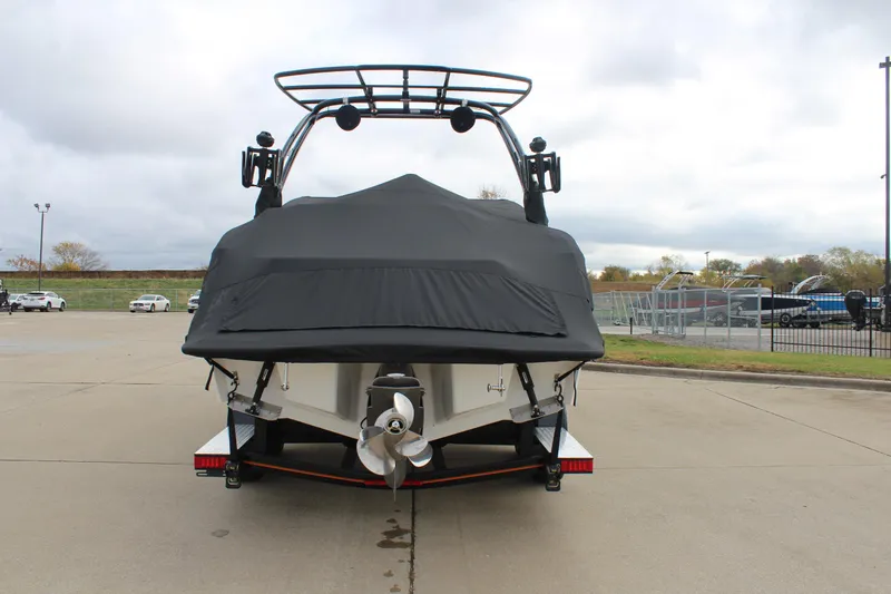 Slide: The Image of 2024 Cobalt R6 boat with cover, parked on concrete lot. - 13