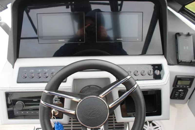 Slide: The Image of 2024 Cobalt R6 boat dashboard with dual screens and steering wheel. - 24