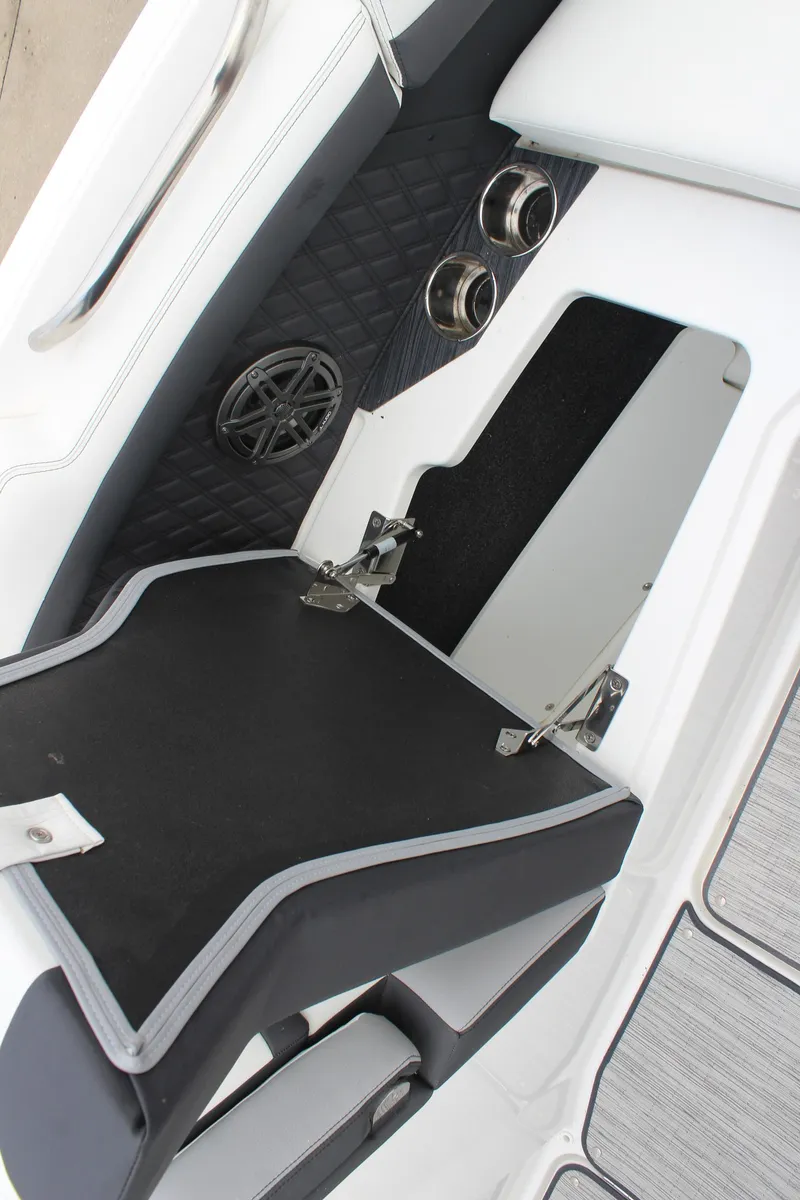 Slide: The Image of 2024 Cobalt R6 boat interior storage compartment with speaker and cup holders. - 32