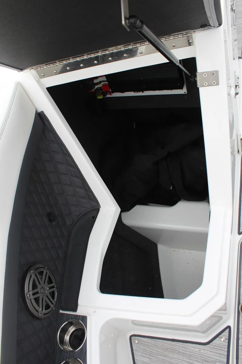 Slide: The Image of 2024 Cobalt R6 boat interior storage compartment with speaker and modern design. - 34