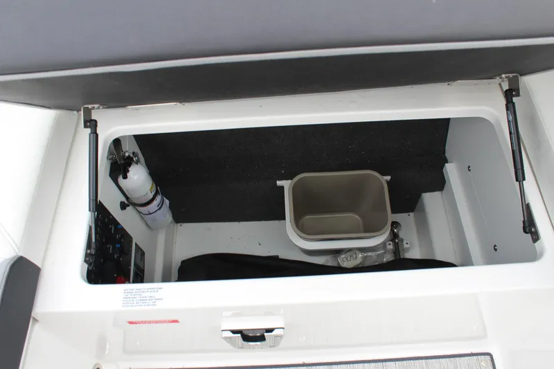 Slide: The Image of 2024 Cobalt R6 storage compartment with fire extinguisher and container. - 36