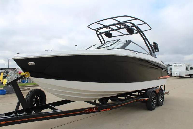 Slide: The Image of 2024 Cobalt R6 boat on trailer, black and white design, parked outdoors. - 5