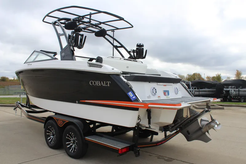 Slide: The Image of 2024 Cobalt R6 boat on trailer, black and white design, outdoor setting. - 7