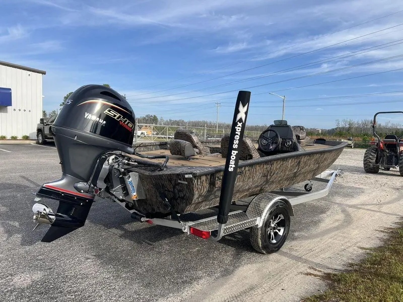 Slide: The Image of 2025 Xpress H18 Bass boat with Yamaha engine on trailer, parked outdoors. - 6