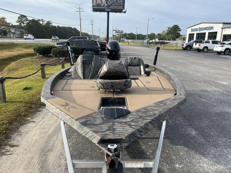 Slide: The Image of 2025 Xpress H18 Bass boat on trailer in parking lot. - 7