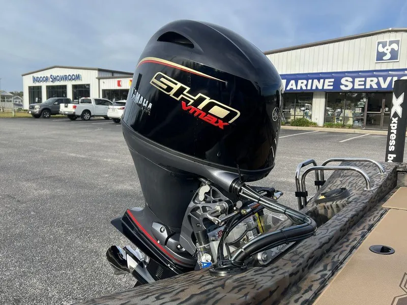 Slide: The Image of 2025 Xpress H18 Bass boat with Yamaha VMAX engine in a marine service lot. - 9