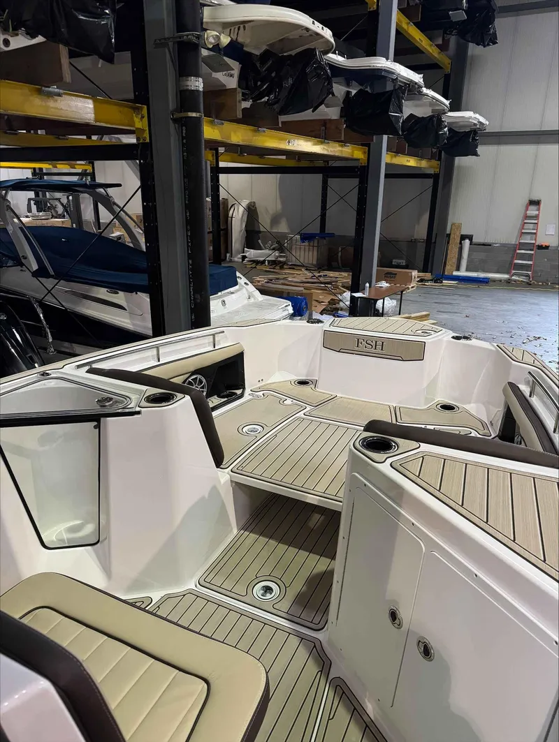 Slide: The Image of 2023 Yamaha Boats 255FSH SPORT E interior in storage facility. - 11