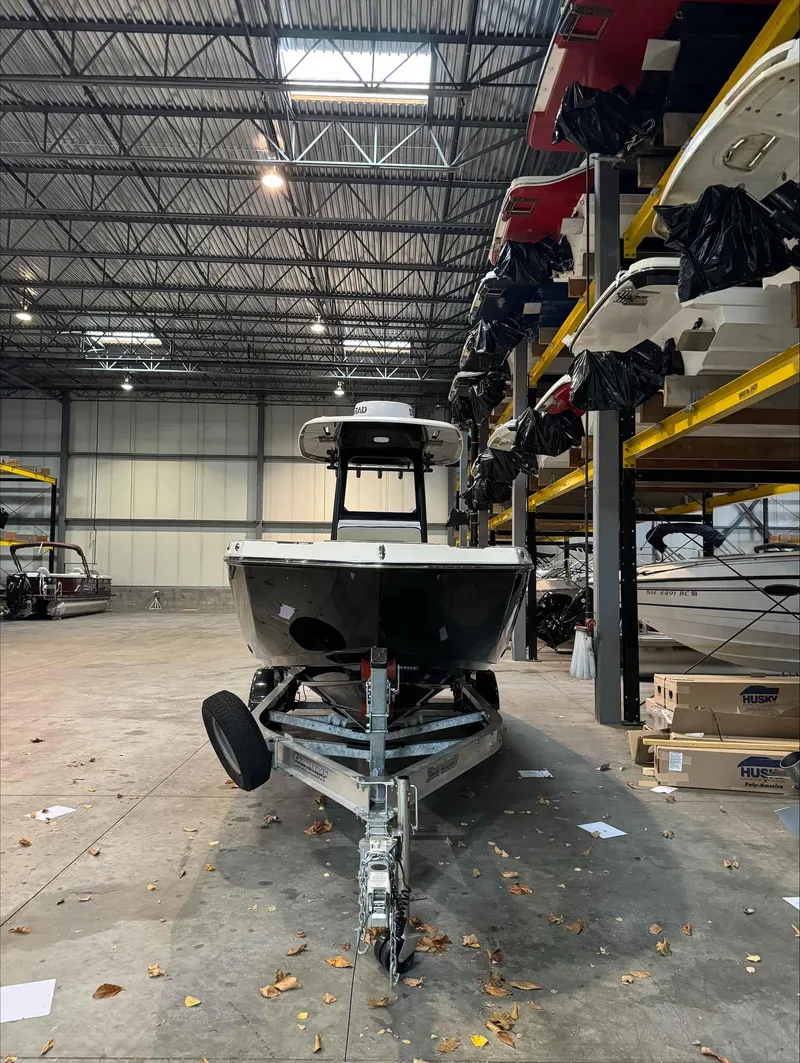 Slide: The Image of 2023 Yamaha Boats 255FSH SPORT E in warehouse, front view, on trailer. - 4