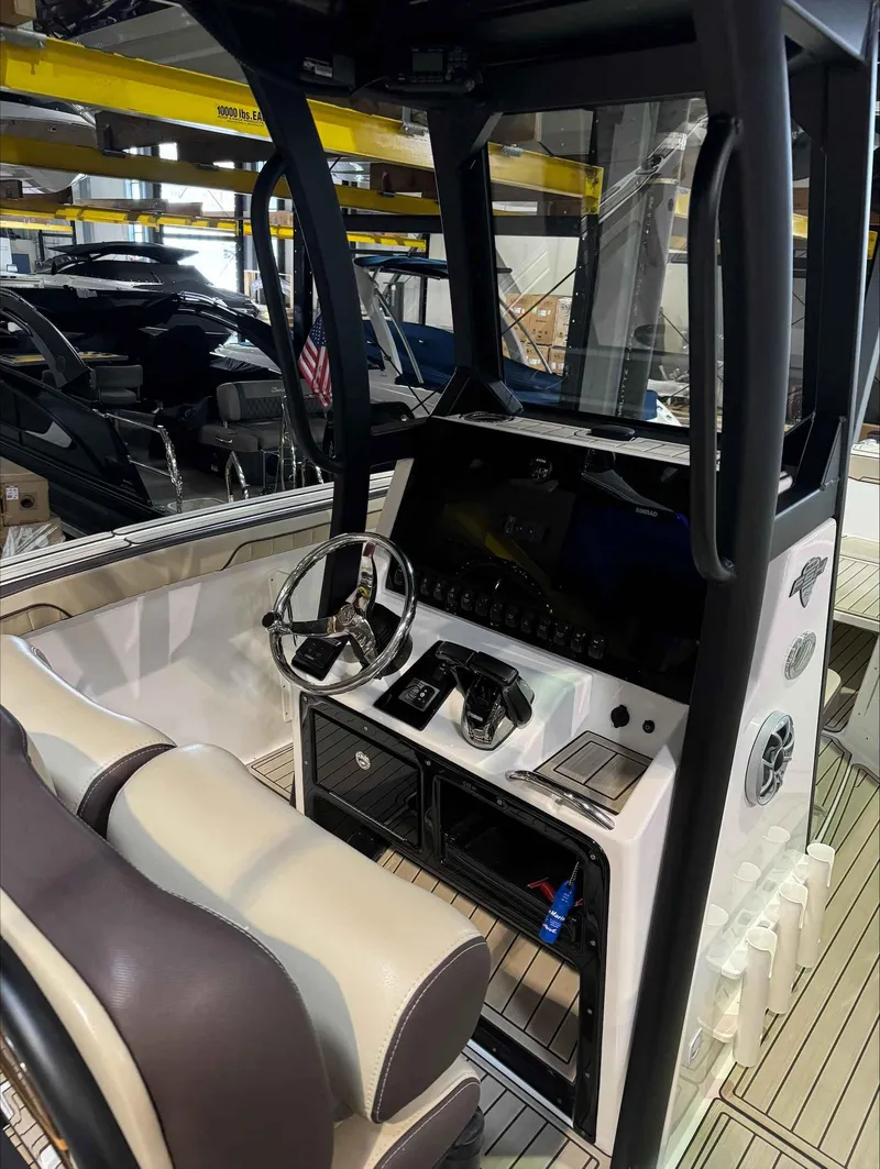 Slide: The Image of 2023 Yamaha Boats 255FSH SPORT E cockpit with modern controls and seating. - 9