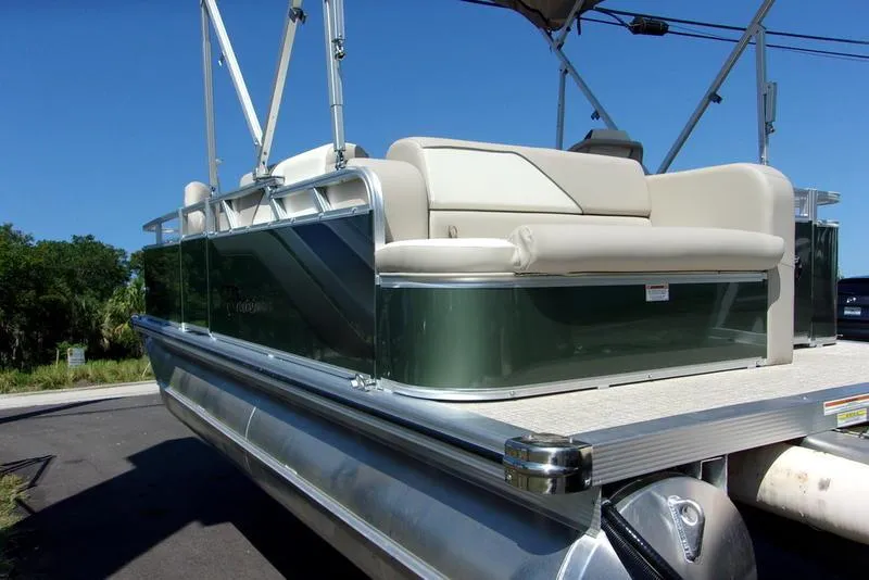 Slide: The Image of 2023 Tahoe Sport Bow 17 FT pontoon boat with beige seating and green exterior. - 13