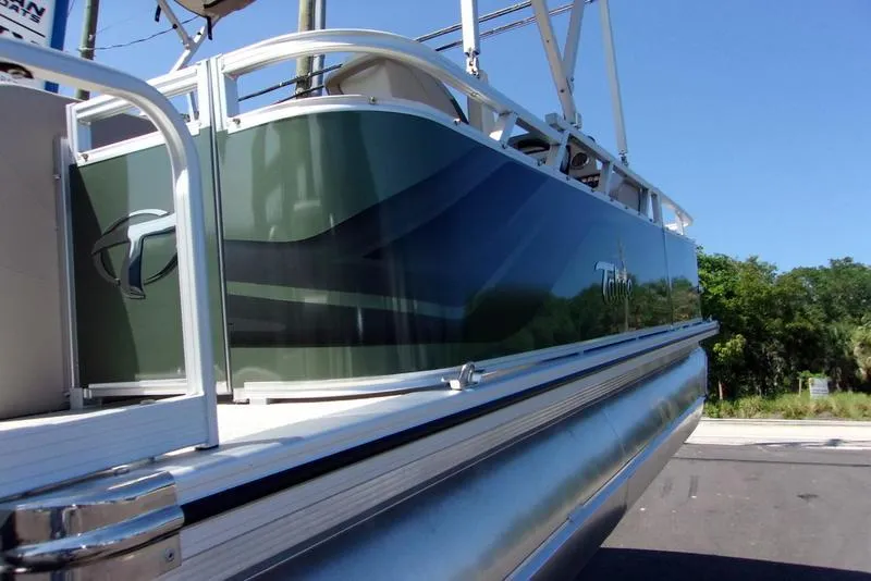 Slide: The Image of 2023 Tahoe Sport Bow 17 FT boat, sleek design, docked outdoors. - 4