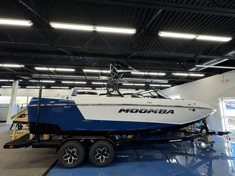 Slide: The Image of 2025 Moomba Mojo boat on trailer in showroom. - 0
