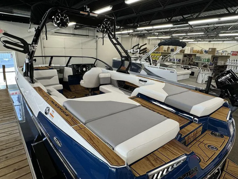 Slide: The Image of 2025 Moomba Mojo boat with sleek interior and modern design in showroom. - 15