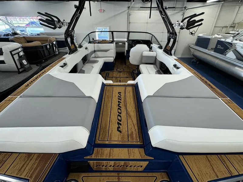Slide: The Image of 2025 Moomba Mojo boat interior with spacious seating and modern design. - 17
